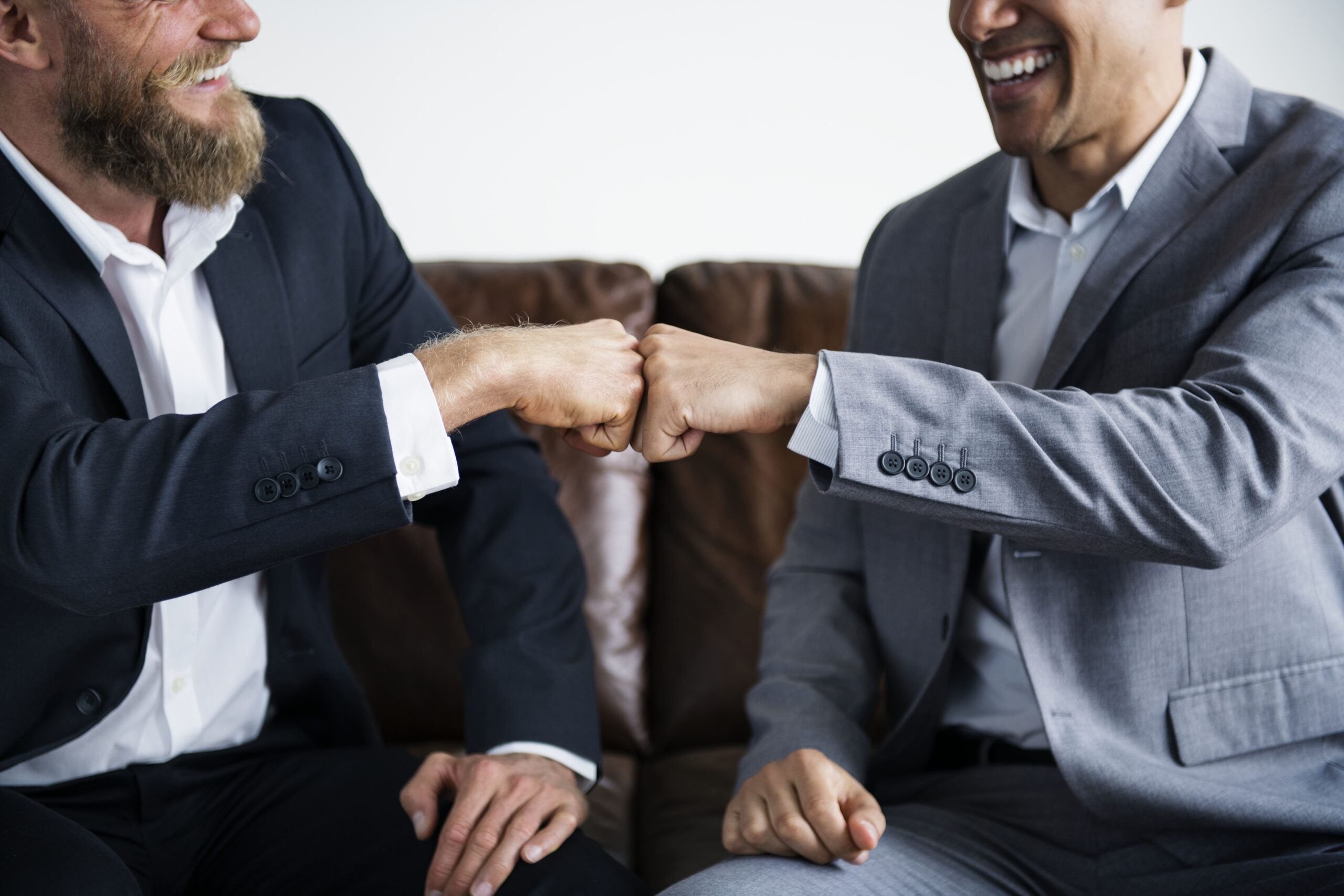 Two businessman sitting on a couch